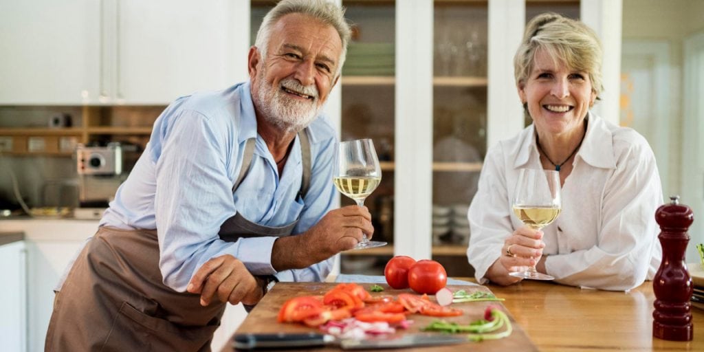 Happy couple prepping a meal in their aging-in-place designed home